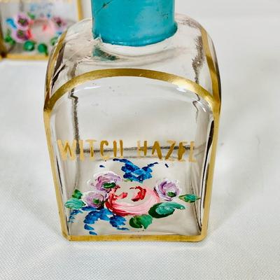 LOT 44: Vintage Vanity Necessity Including Hand Painted Glass Bottles, Metal Power Bottles, a Ceramic Jaw with Mirror Lid and More