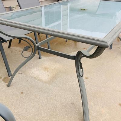 LOT 46: Outdoor Glass Top Table and Four Chairs