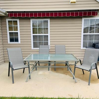 LOT 46: Outdoor Glass Top Table and Four Chairs