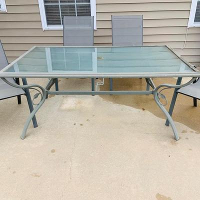 LOT 46: Outdoor Glass Top Table and Four Chairs