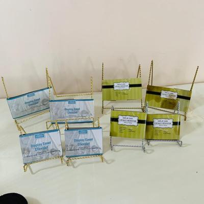 LOT 52: Basketful of Candles, Frames and Display Easels and Brass Candle Sticks and More