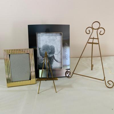 LOT 52: Basketful of Candles, Frames and Display Easels and Brass Candle Sticks and More
