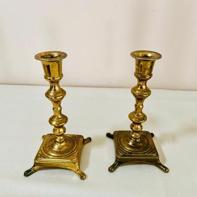 LOT 52: Basketful of Candles, Frames and Display Easels and Brass Candle Sticks and More