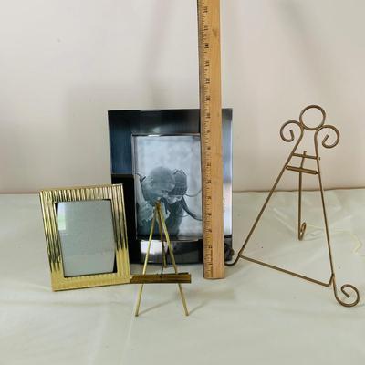 LOT 52: Basketful of Candles, Frames and Display Easels and Brass Candle Sticks and More
