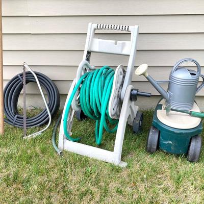 LOT 60: Lawn and Garden - Hose and Hose Mobile Holder, Rakes, Step 2 Rolling Garden Cart / Seat with Contents and More