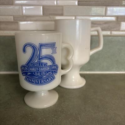 LOT 90: Glass Collection with Avocado Green Glass Mugs, Amber Glass Mug, Milk Glass, 25th Harley Davidson Mug, Coca-Cola Glasses, Cowtown...