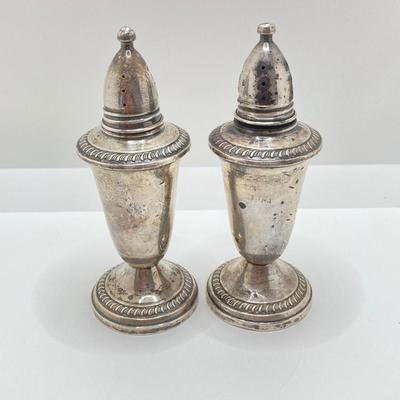 LOT 179: Weighted Sterling Salt and Pepper Shakers and Four Sterling Round Coasters