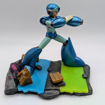 LOT 104: Captain America Tumbler, Marvel Vs. Capcom Diorama Figure, Mega Man, Spider Man Statues & Infinite Collector's Edition...