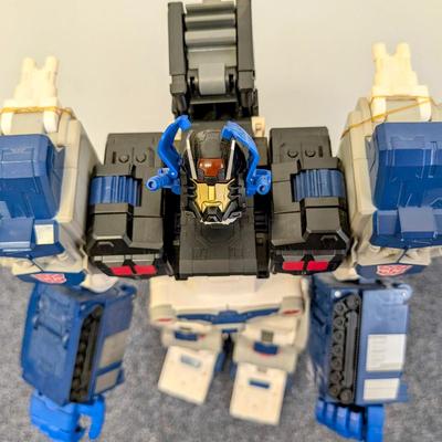 LOT 108: Transformers Generations Legacy Titan Cybertron & A Large Assortment Of Other Transformer Action Figures.