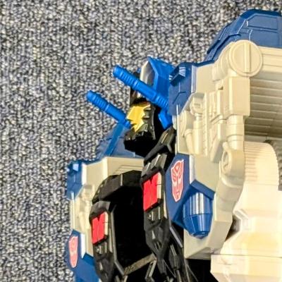 LOT 108: Transformers Generations Legacy Titan Cybertron & A Large Assortment Of Other Transformer Action Figures.