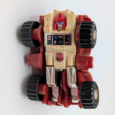 LOT 108: Transformers Generations Legacy Titan Cybertron & A Large Assortment Of Other Transformer Action Figures.