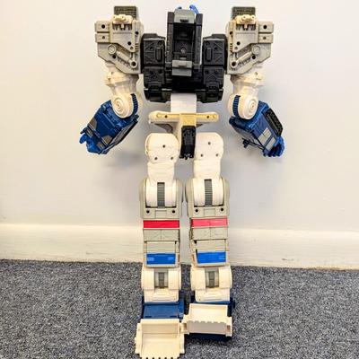 LOT 108: Transformers Generations Legacy Titan Cybertron & A Large Assortment Of Other Transformer Action Figures.