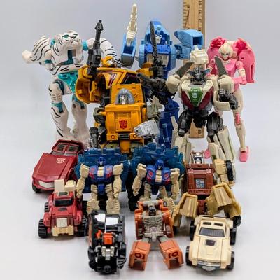 LOT 108: Transformers Generations Legacy Titan Cybertron & A Large Assortment Of Other Transformer Action Figures.