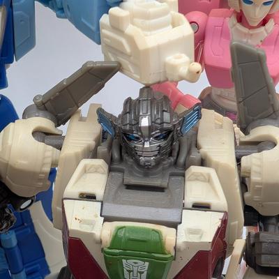 LOT 108: Transformers Generations Legacy Titan Cybertron & A Large Assortment Of Other Transformer Action Figures.
