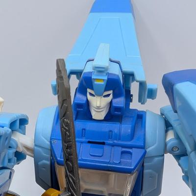 LOT 108: Transformers Generations Legacy Titan Cybertron & A Large Assortment Of Other Transformer Action Figures.