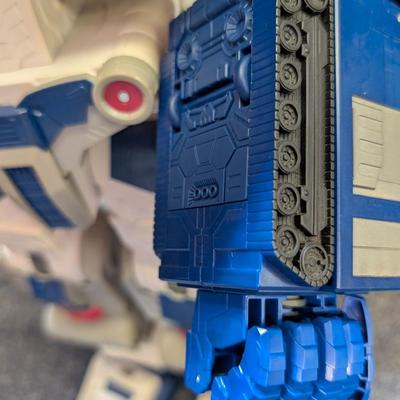 LOT 108: Transformers Generations Legacy Titan Cybertron & A Large Assortment Of Other Transformer Action Figures.