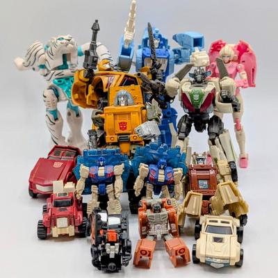 LOT 108: Transformers Generations Legacy Titan Cybertron & A Large Assortment Of Other Transformer Action Figures.