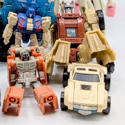 LOT 108: Transformers Generations Legacy Titan Cybertron & A Large Assortment Of Other Transformer Action Figures.