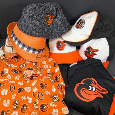 LOT 228: Baltimore Oriole Gear, Button Down Shortsleeve Shirt, Pullover, Sweatshirt, 2 Straw Hats, One Signed & 3 Baseball Caps. No...