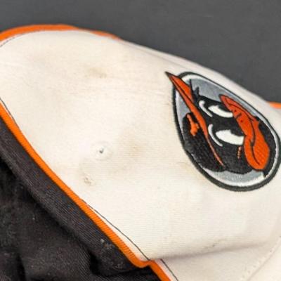 LOT 228: Baltimore Oriole Gear, Button Down Shortsleeve Shirt, Pullover, Sweatshirt, 2 Straw Hats, One Signed & 3 Baseball Caps. No...