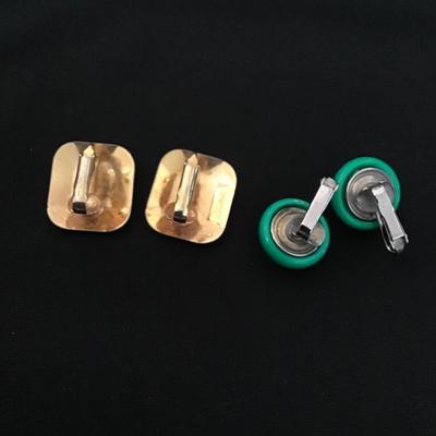 Two pairs of vintage gold and silver toned green enameled clip on earrings