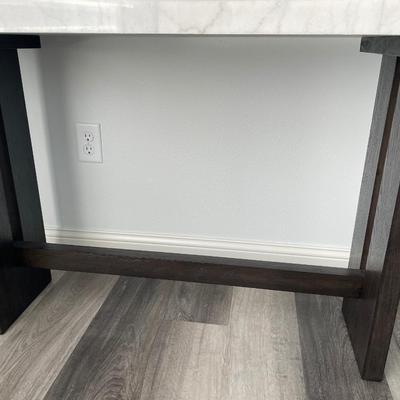 Sale Photo Thumbnail #16: Sleek Marble top with dark wood legs from Ashley Furniture
52” w x 16” d x 30” t
