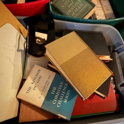Two large bins of books, mostly religious themed