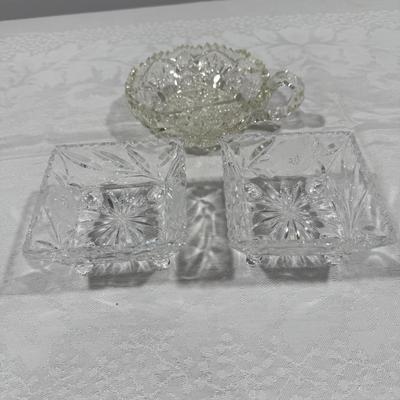 Three crystal pieces including two matching trays