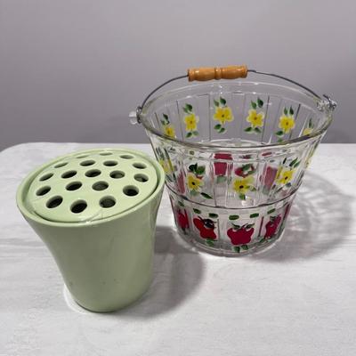 One glass bucket with flowers and apples and green container