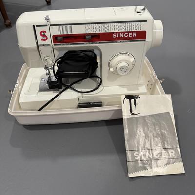 Singer sewing machine with case and instruction booklet