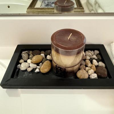 Candle with stones on tray