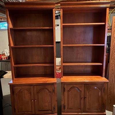 Two matching beautiful wood bookcases with cabinets