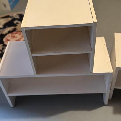 Four white shoe cubes and holders