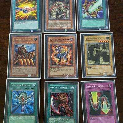 Lot of 54 yugioh cards with deck sleeves and tin