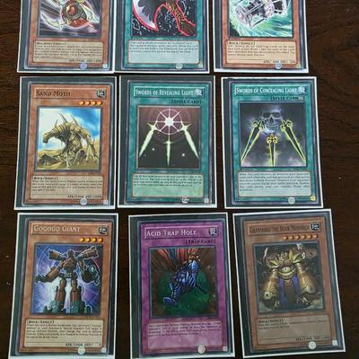 Lot of 54 yugioh cards with deck sleeves and tin