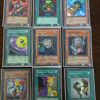 Lot of 54 yugioh cards with deck sleeves and tin
