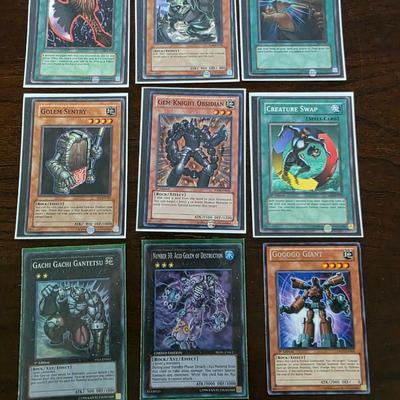 Lot of 54 yugioh cards with deck sleeves and tin