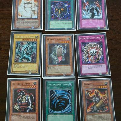 Lot of 54 yugioh cards with deck sleeves and tin