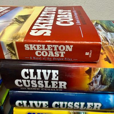 Sale Photo Thumbnail #523: 11 books:: 10 hardcovers and 1 softcover. Titles include: Skeleton Coast, Crescent Dawn, and The Wrecker.  All in very good condition.