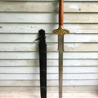 LOT 75: Large Barbarian Wood / Brass Handle Sword with Black Sheath
