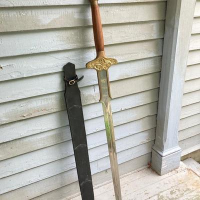 LOT 75: Large Barbarian Wood / Brass Handle Sword with Black Sheath