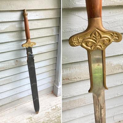 LOT 75: Large Barbarian Wood / Brass Handle Sword with Black Sheath