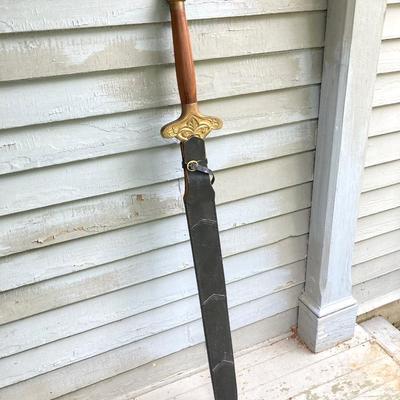 LOT 75: Large Barbarian Wood / Brass Handle Sword with Black Sheath