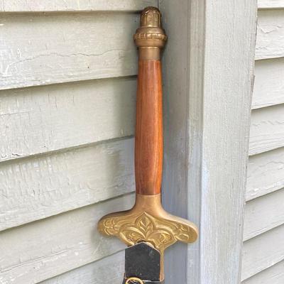 LOT 75: Large Barbarian Wood / Brass Handle Sword with Black Sheath