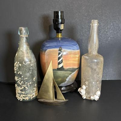 LOT 85: Seaside Collection: Ceramic Lighthouse Lamp, Wooden Carved Pelican, Sea Glass Bottles w/Barnacles, Lighthouse Painting on Slate,...