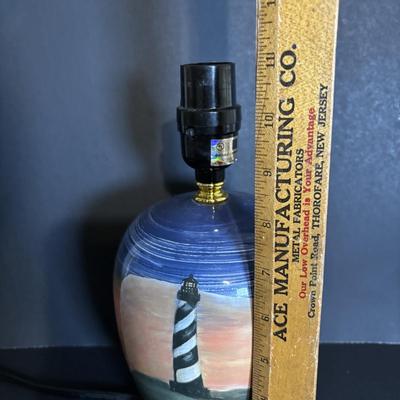 LOT 85: Seaside Collection: Ceramic Lighthouse Lamp, Wooden Carved Pelican, Sea Glass Bottles w/Barnacles, Lighthouse Painting on Slate,...