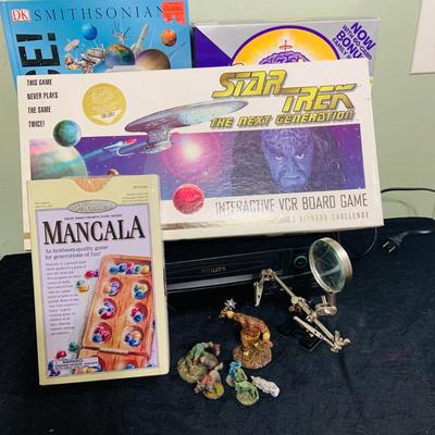 LOT 193: Star Trek Next Generation VCR Board Game with Philips VCR, D&D Figures, Never Used Mancala Game Space Book and More