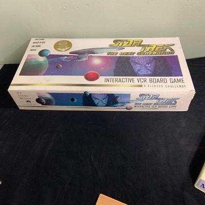 LOT 193: Star Trek Next Generation VCR Board Game with Philips VCR, D&D Figures, Never Used Mancala Game Space Book and More