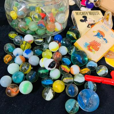 LO 207: Collection of Vintage Toys, Game and Marbles Featuring Tandy Caveman Electronic Table Top Game, Fred Flintstone Wooden Puzzle,...