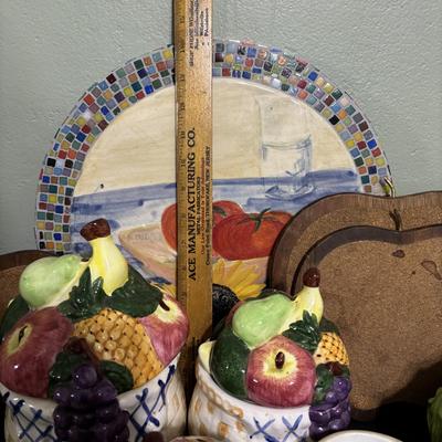 LOT 220: Fruit & Veggie Kitchen Collection: Home Interiors Vegetable Plaques, Apple Hot Plates Fruit Canisters, Holland Mold Ceramic...